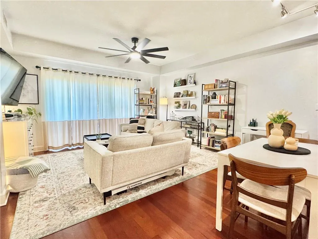 Living room with wood finished floors and ceiling fan