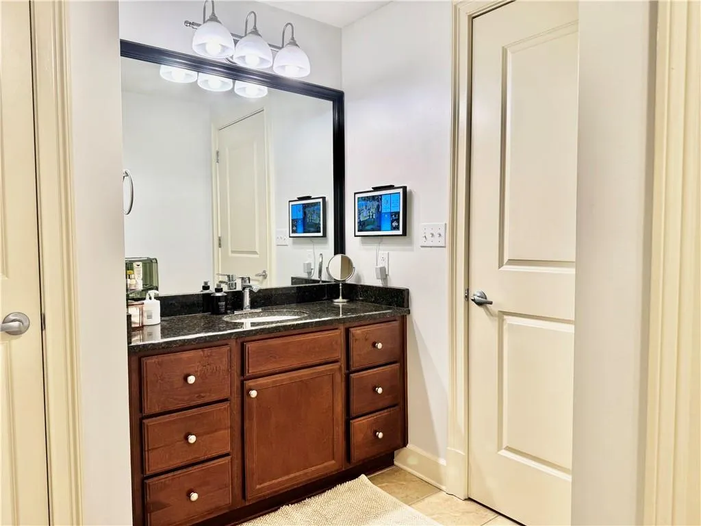 Half bath featuring vanity and light tile patterned floors