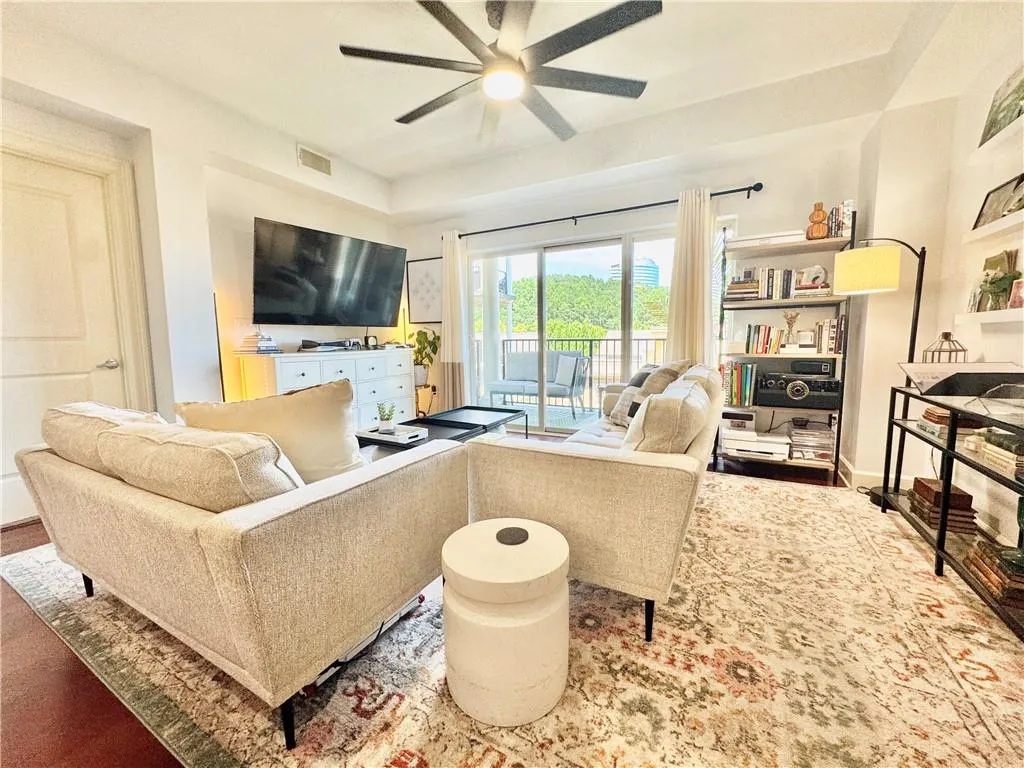 Living area featuring ceiling fan and baseboards