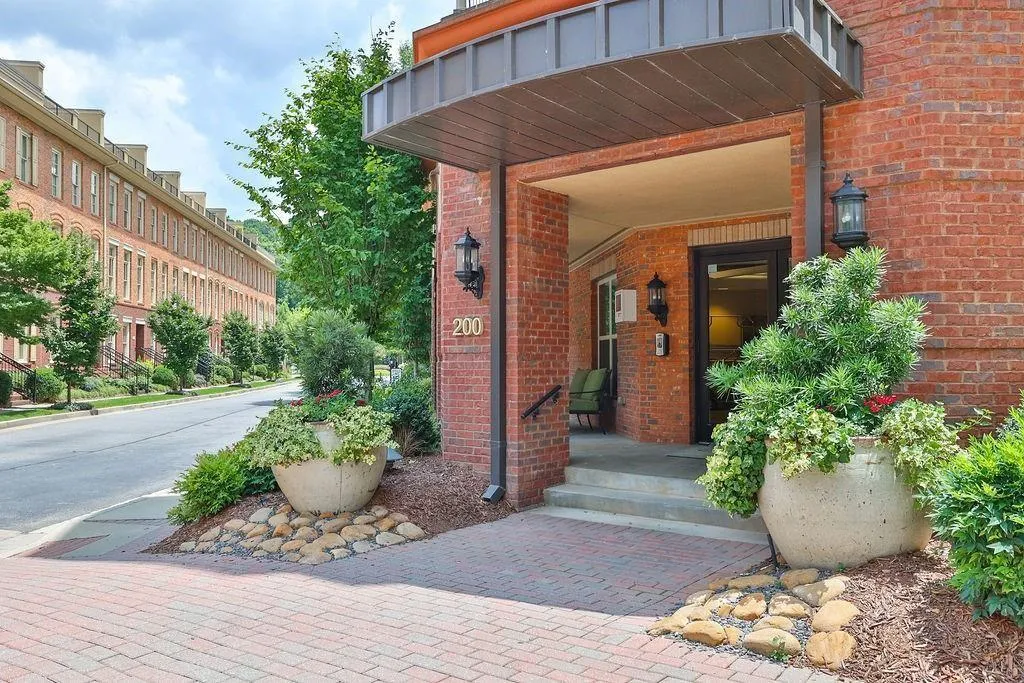 View of exterior entry featuring brick siding