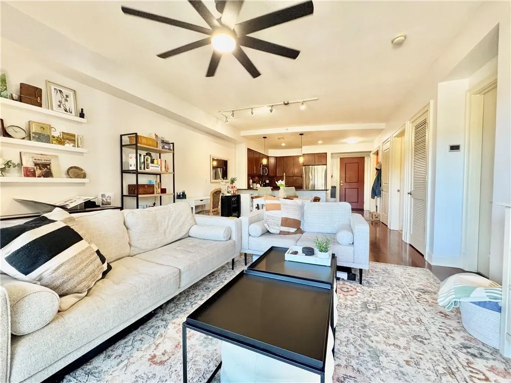 Living area featuring wood finished floors and ceiling fan