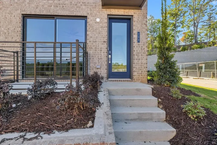 View of exterior entry with brick siding