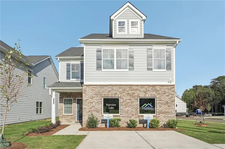 Two-story residence featuring a brick and siding exterior with a prominent dormer