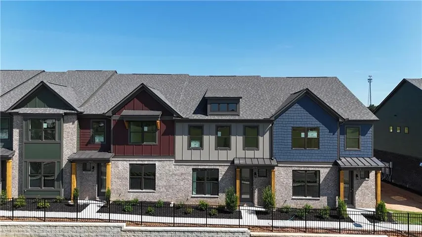 Contemporary townhome development featuring light-colored brick facades and multi-toned siding