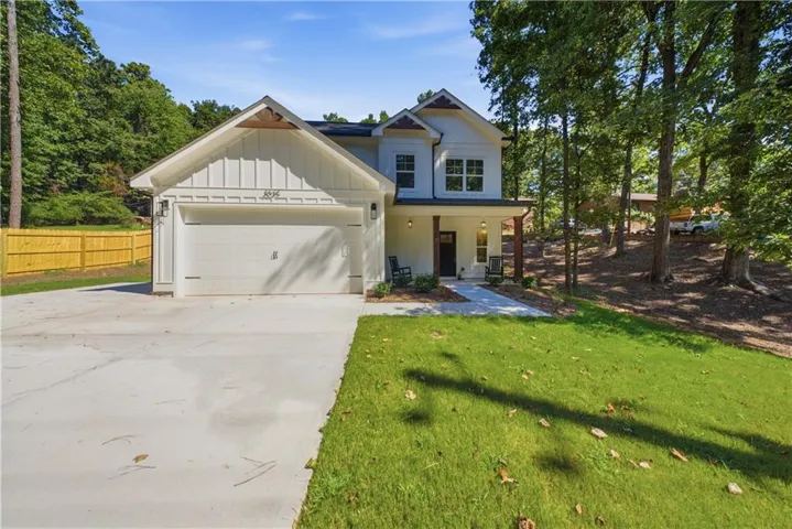 Contemporary two-story exterior with an attached garage, covered front porch, and a concrete driveway