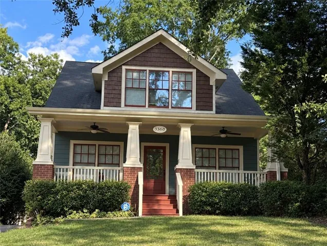 Craftsman-style exterior with a covered porch, brick detailing, and a prominent gable