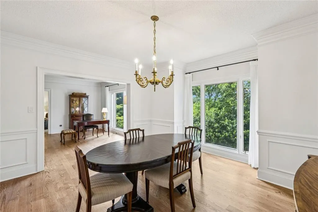 solid oak floors and lovely tree coverage on the southern exposure  living room through the left portal...