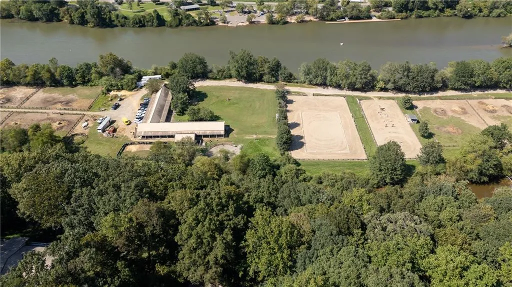 Aerial view of property and surrounding area with a large body of water