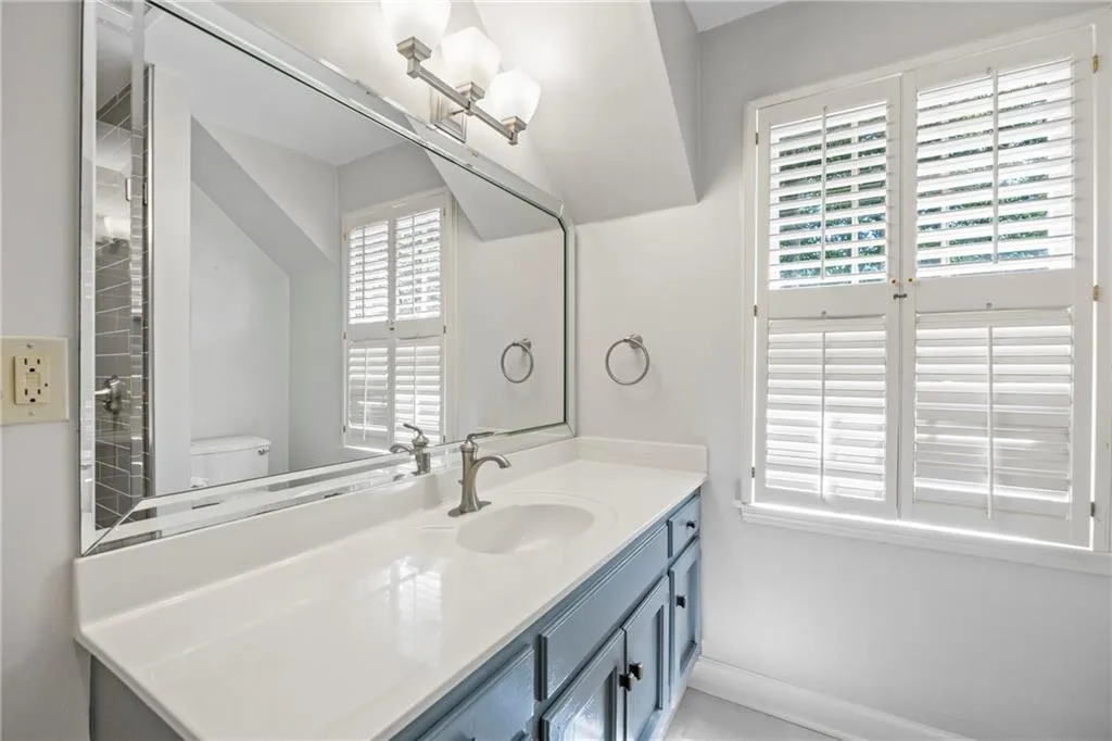Full bath with vanity and a chandelier