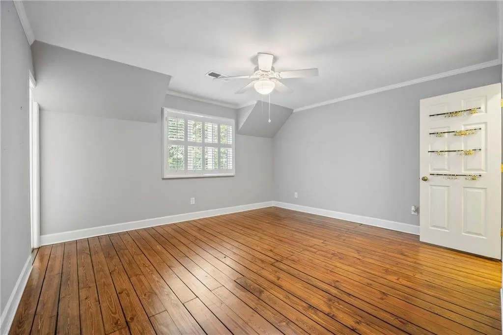 Additional living space featuring hardwood / wood-style flooring and a ceiling fan