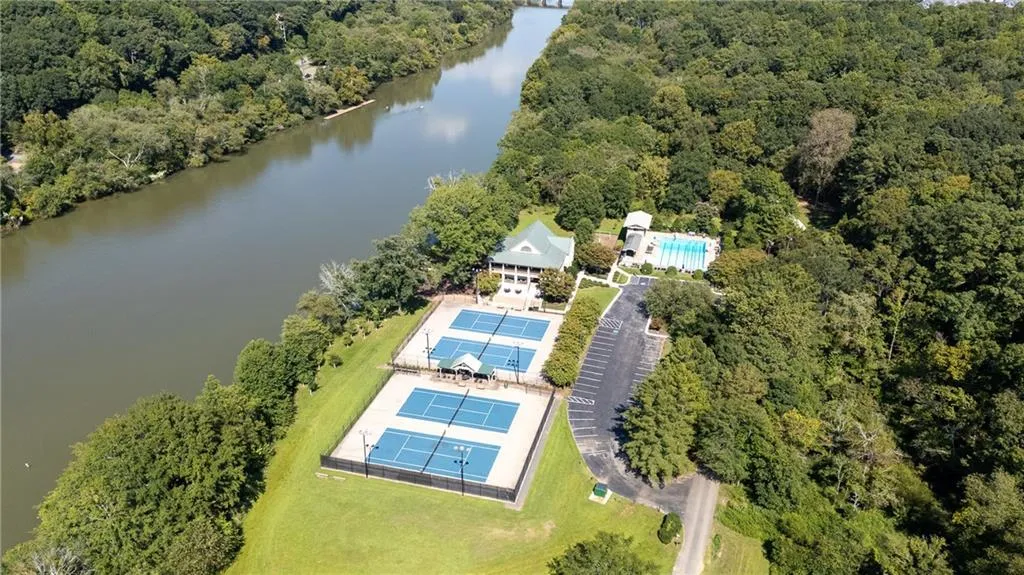 Drone / aerial view of a large body of water and a heavily wooded area