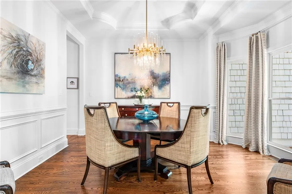 Dining area featuring tray ceiling, ornamental molding, wainscoted walls and hardwood floors Dining area featuring tray ceiling, ornamental molding, wainscoted walls and hardwood floors