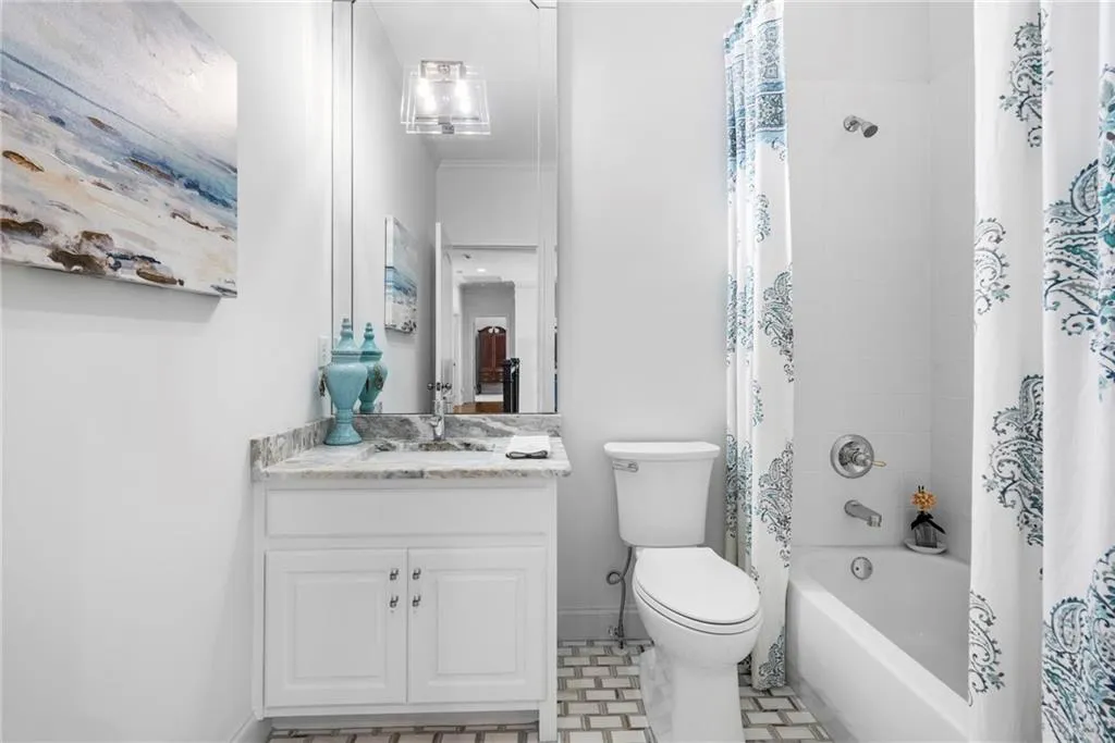 Full bath with marble flooring, shower/tub combo, and linen closet. Full bath with marble flooring, shower/tub combo, and linen closet.
