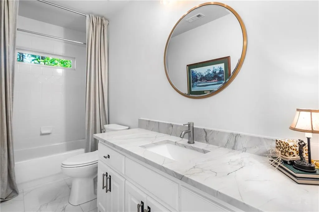 Terrace-level Bathroom featuring shower/tub combo, spacious vanity Terrace-level Bathroom featuring shower/tub combo, spacious vanity