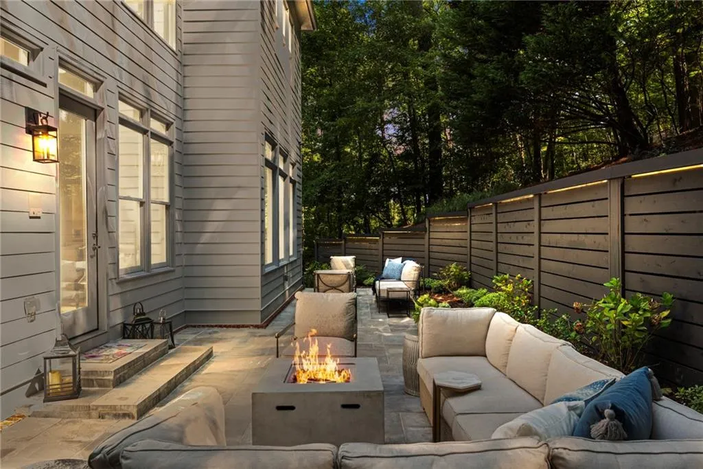 Backyard Fenced with Down Lighting with a patio and an outdoor living space with a fire pit Backyard Fenced with Down Lighting with a patio and an outdoor living space with a fire pit