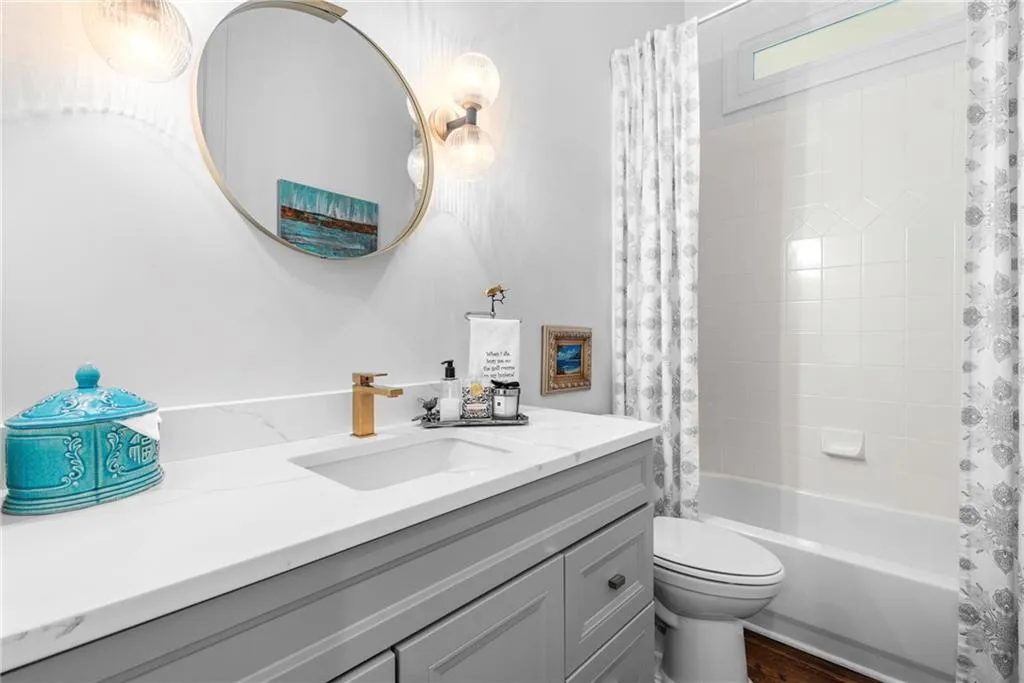 Bathroom-Main level  with shower / tub combo, vanity and door to the bedroom/office Bathroom-Main level  with shower / tub combo, vanity and door to the bedroom/office