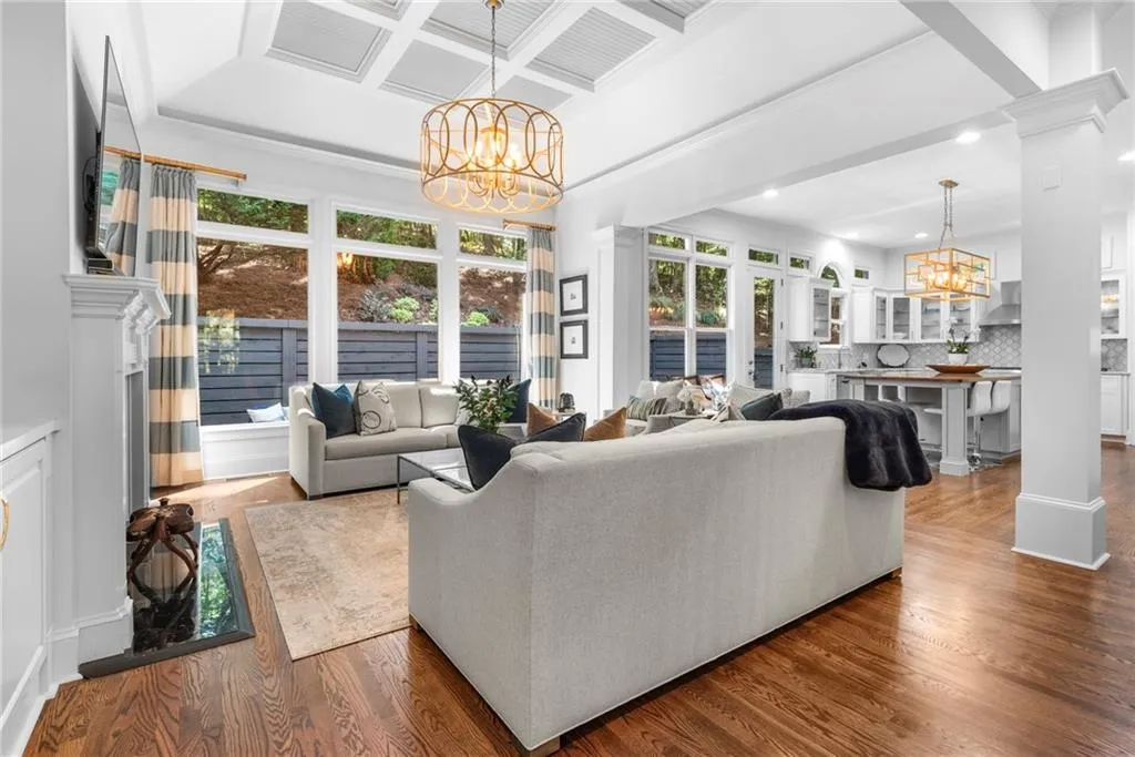 Family room featuring plenty of natural light with a wall of windows, coffered ceiling,
built-ins and designer chandelier Family room featuring plenty of natural light with a wall of windows, coffered ceiling,
built-ins and designer chandelier