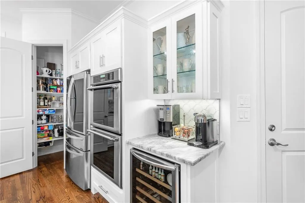 Kitchen featuring coffee bar area with beverage wine cooler and walk-in pantry Kitchen featuring coffee bar area with beverage wine cooler and walk-in pantry