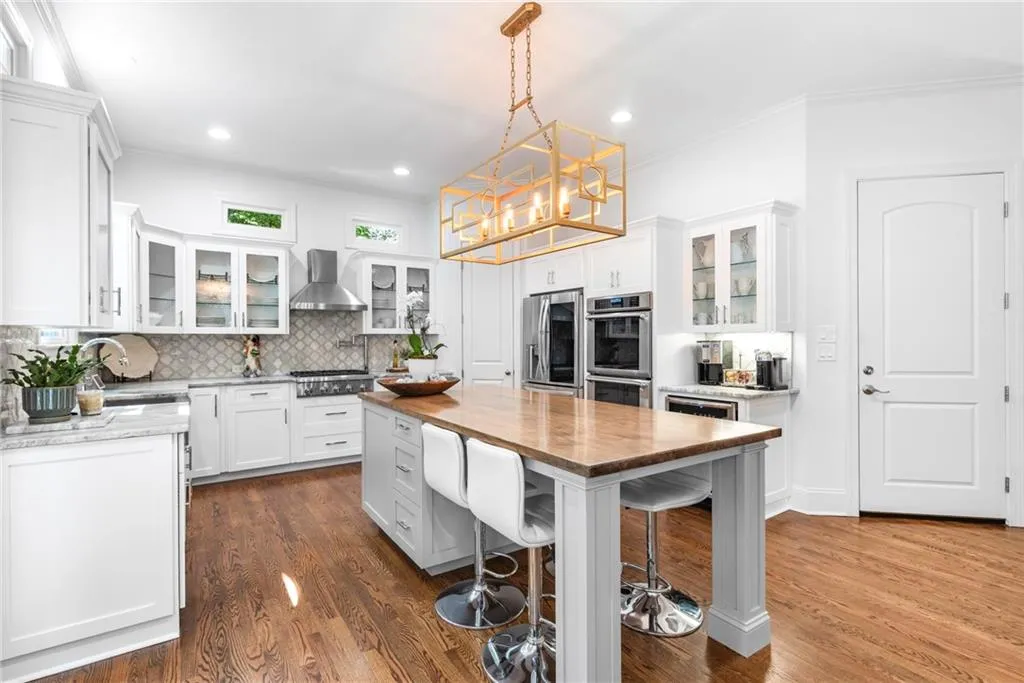 Kitchen features a four-seating island area, stainless steel microwave draw, mixer/appliance pull out cabinet, two spice pull out cabinets and storage drawers Kitchen features a four-seating island area, stainless steel microwave draw, mixer/appliance pull out cabinet, two spice pull out cabinets and storage drawers