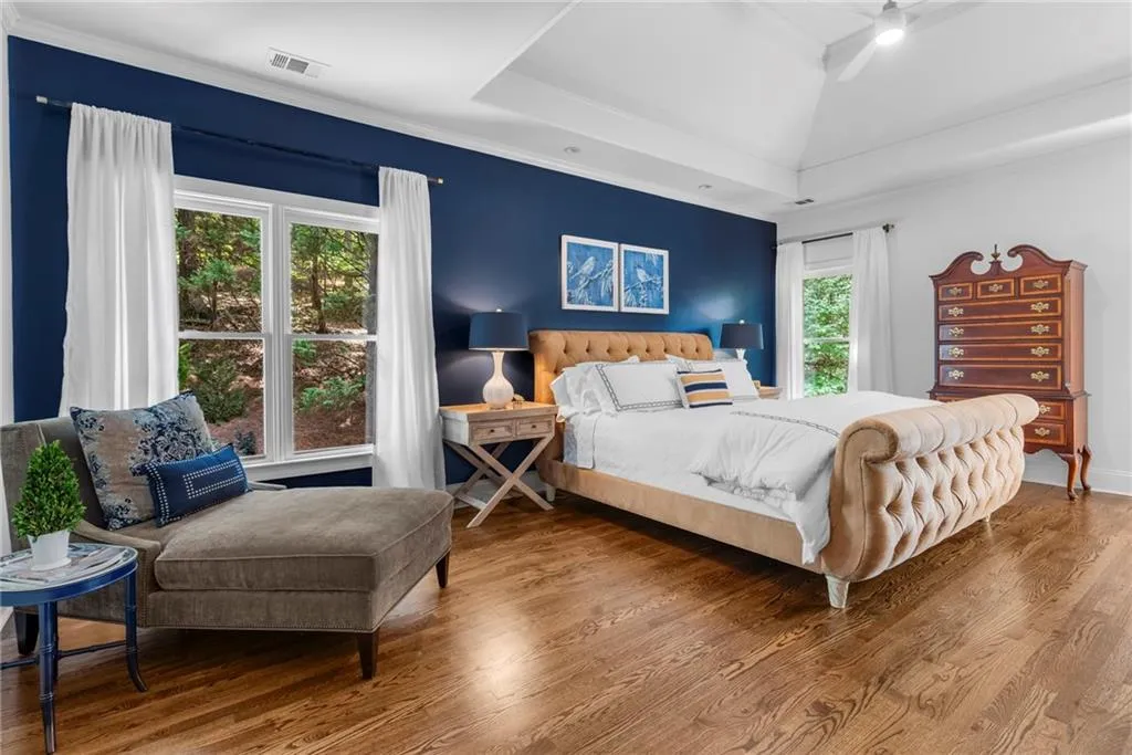 Primary Bedroom featuring sitting area,10’ ceiling with tray, ornamental molding, recessed lighting, ceiling fan and hardwood floors Primary Bedroom featuring sitting area,10’ ceiling with tray, ornamental molding, recessed lighting, ceiling fan and hardwood floors