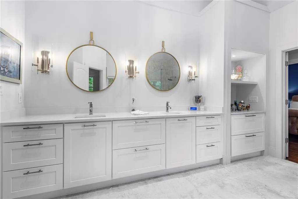 Primary Bath featuring extra-large double vanity with drawer storage.  Sperate vanity area with wall shelves and linen storage drawers. Primary Bath featuring extra-large double vanity with drawer storage.  Sperate vanity area with wall shelves and linen storage drawers.