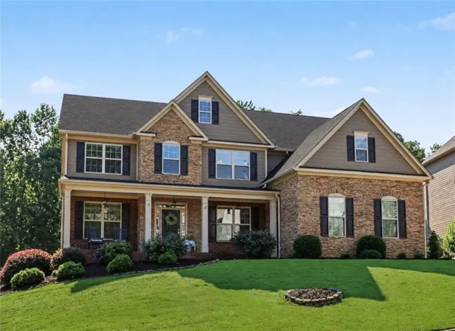 Spacious two-story residence featuring stone and siding exterior