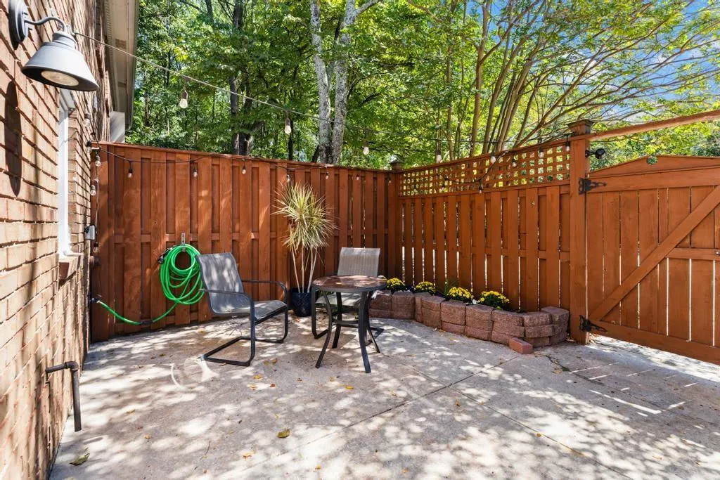 Fenced backyard with a patio and a gate