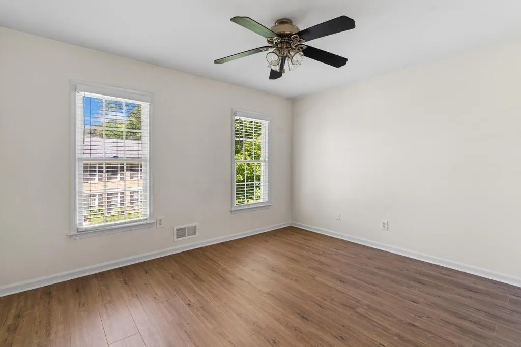 Unfurnished room with wood finished floors and ceiling fan