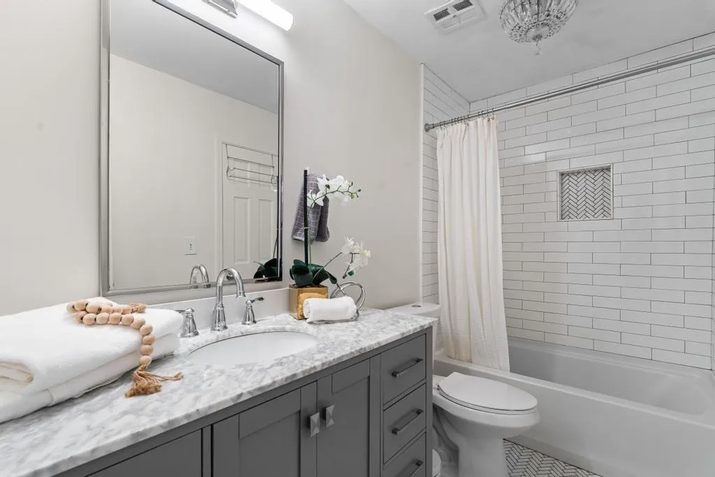 Bathroom with vanity and shower / tub combo with curtain