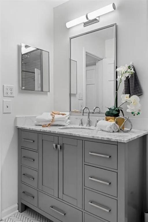 Full bathroom with vanity and light tile patterned floors