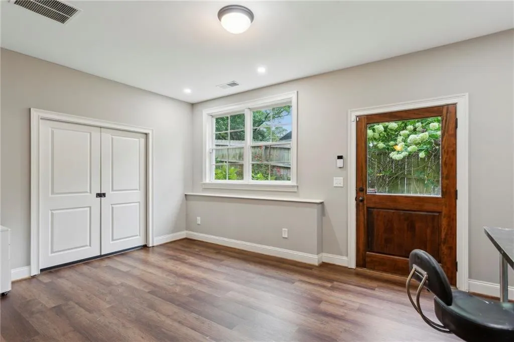 Flexible space with side door to backyard, double pocket doors to the exercise room