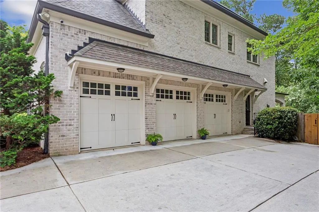 View of the side-entry three-car garage at kitchen level, and side door opening to mud room