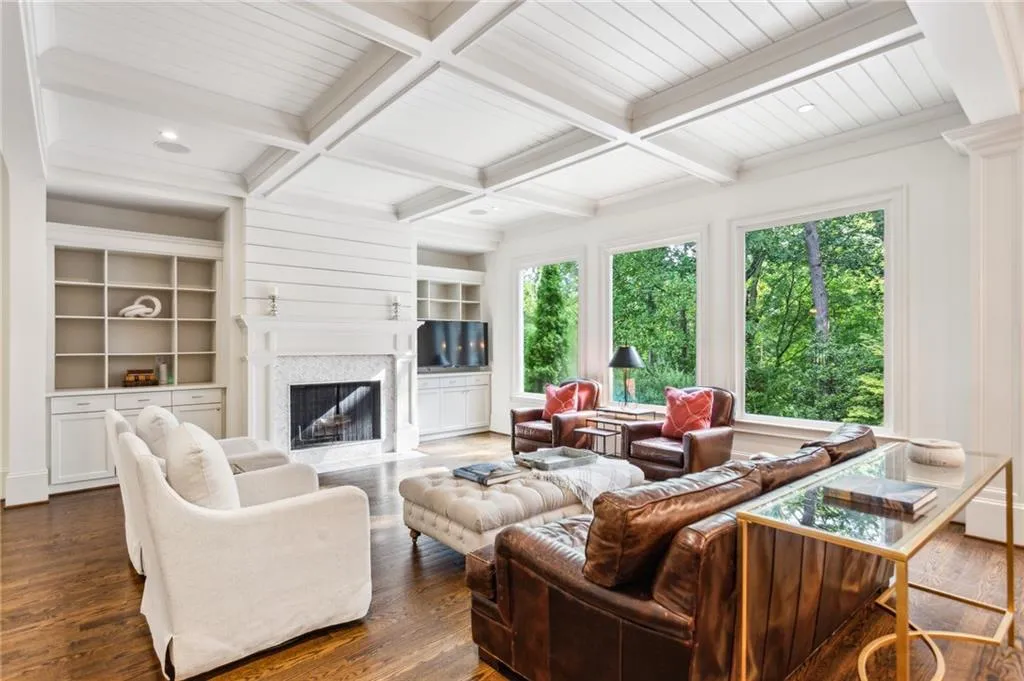 The family room includes built-in bookshelves, cabinets and a deep wood-burning fireplace for roaring fires in the winter