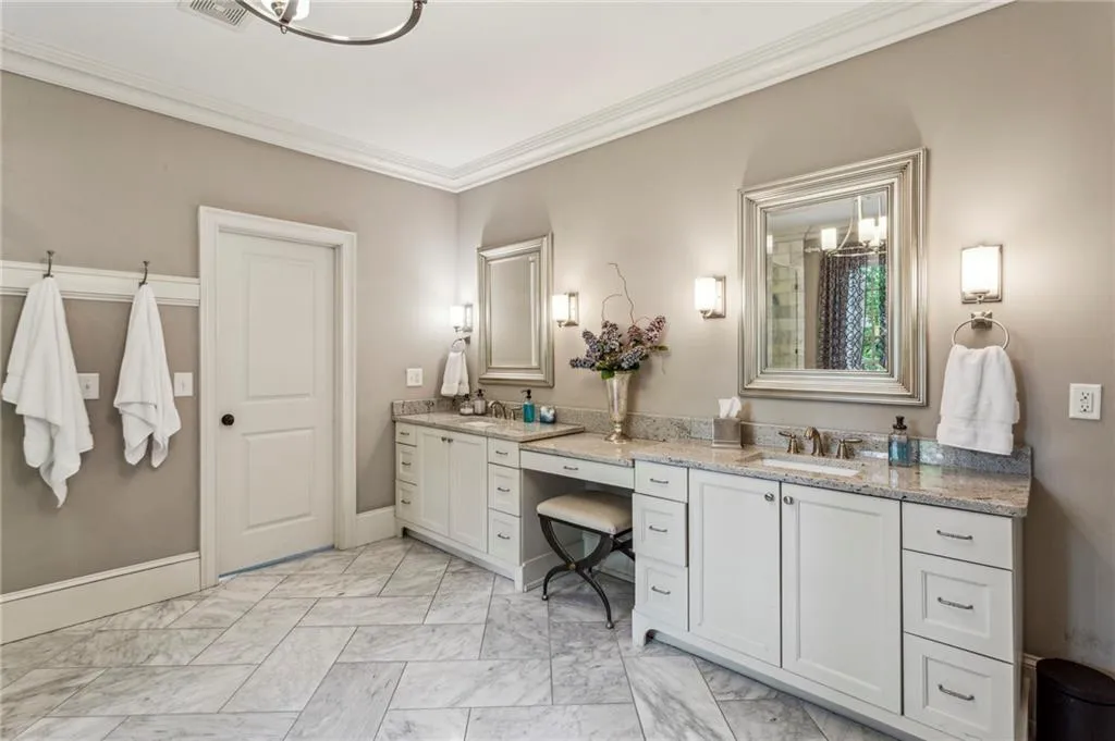 Full bathroom with double vanity, makeup counter space