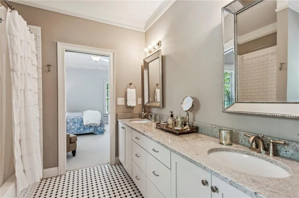Spacious ensuite bathroom with double vanity, and tile patterned floors