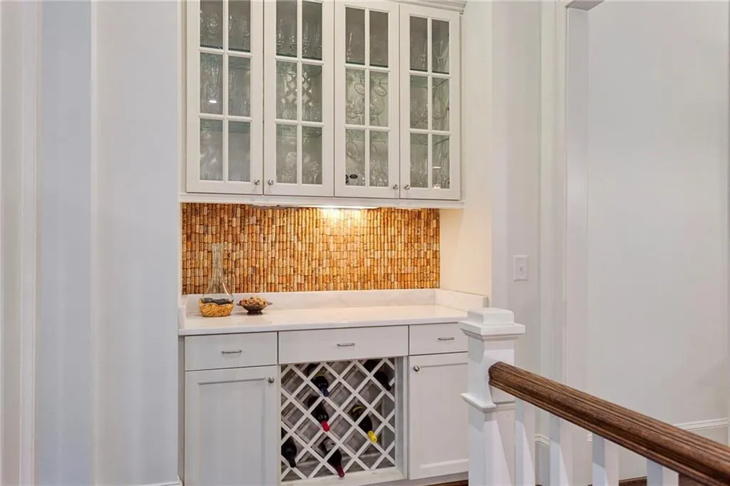 Between the kitchen and dining room with custom backsplash