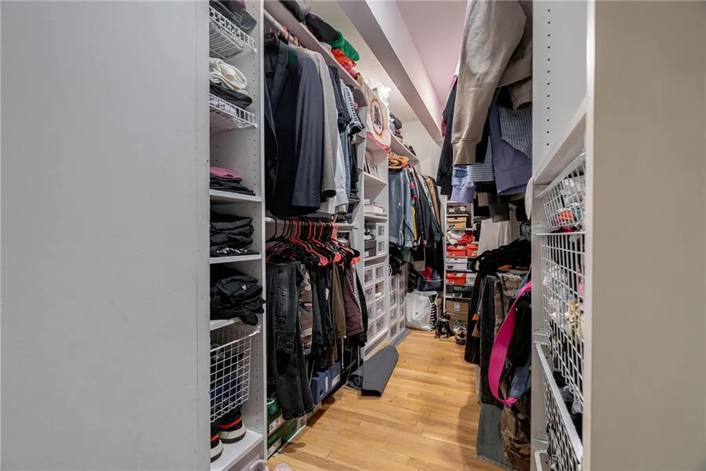 Spacious closet featuring hardwood / wood-style flooring