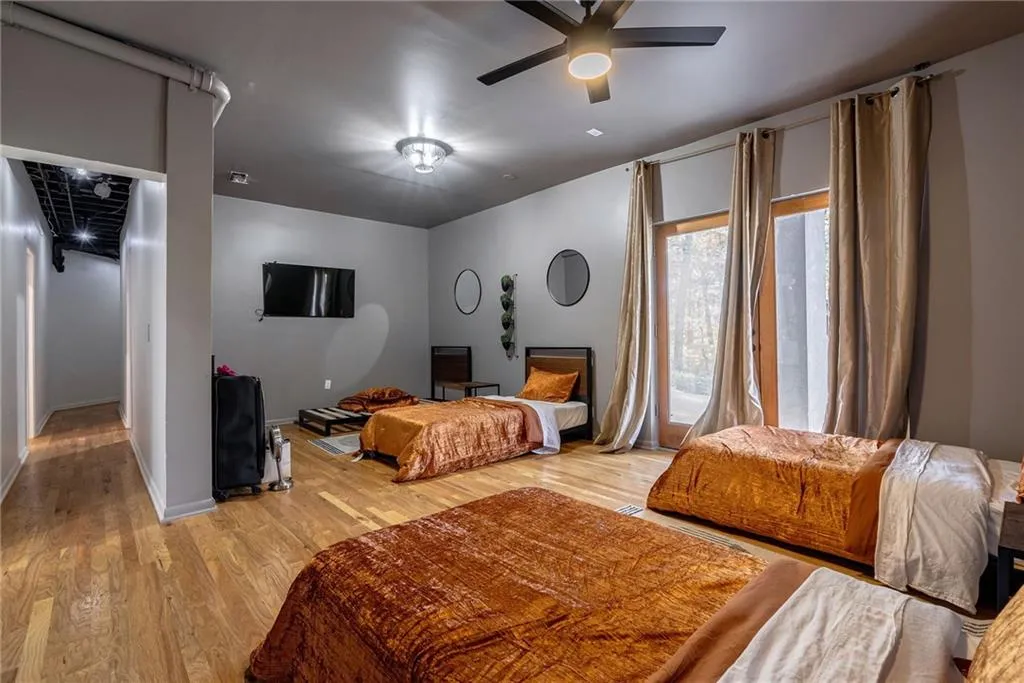 Bedroom with ceiling fan and light wood-type flooring
