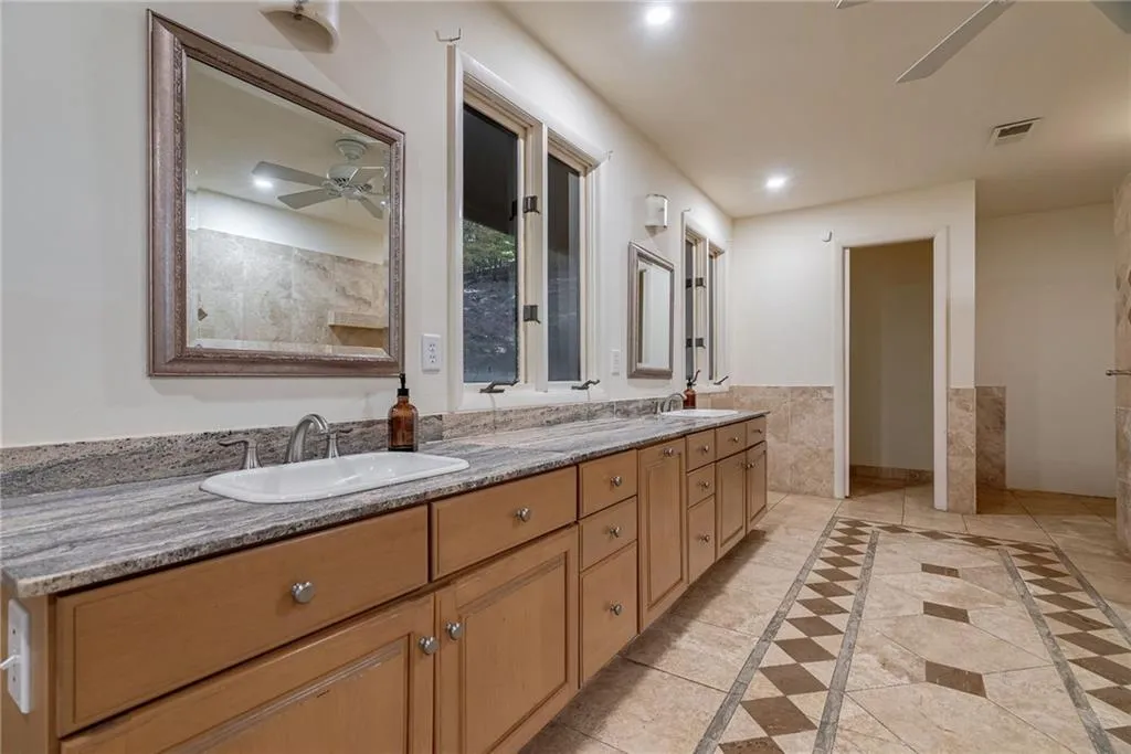 Bathroom featuring tile patterned flooring, vanity, and ceiling fan