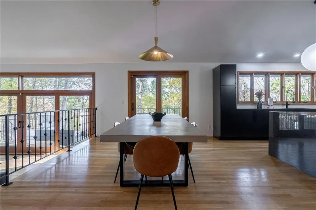 Dining space with light wood-type flooring and sink