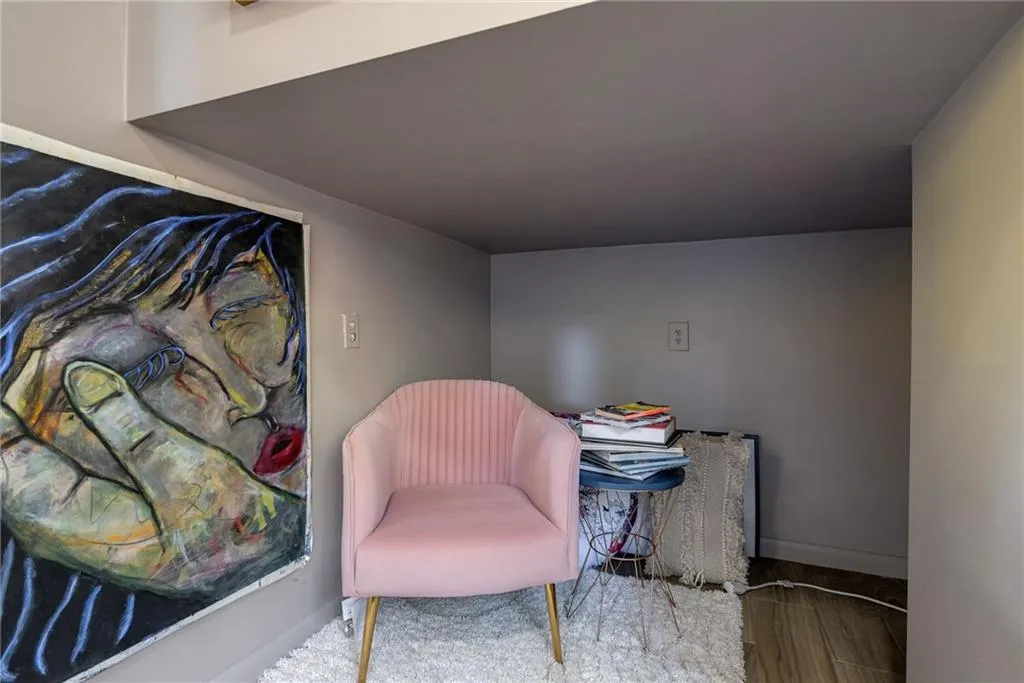 Sitting room with hardwood / wood-style flooring