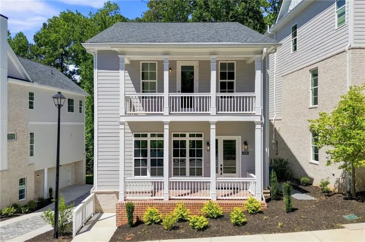 Two-story facade with light gray siding and white trim