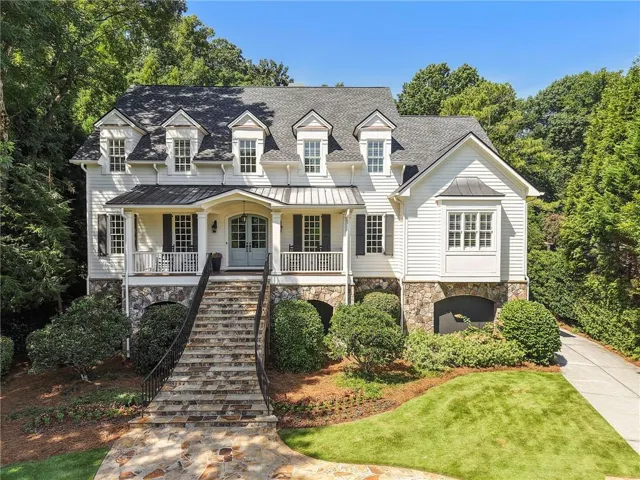 Classic white siding exterior with stone accents