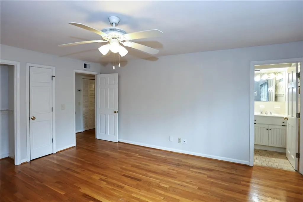 Bedroom with ceiling fan, large closet, full bath