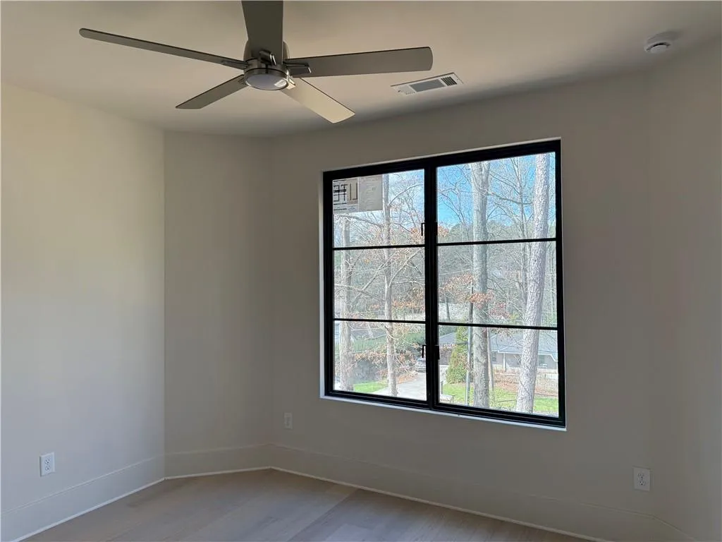 Unfurnished room with a ceiling fan and light wood-style flooring