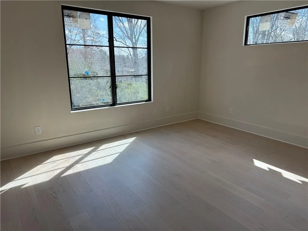 Empty room featuring baseboards and light wood-type flooring