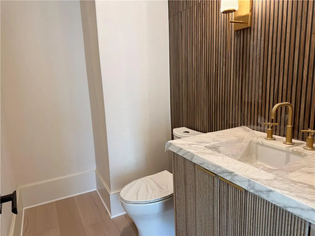 Half bath featuring vanity and light wood finished floors