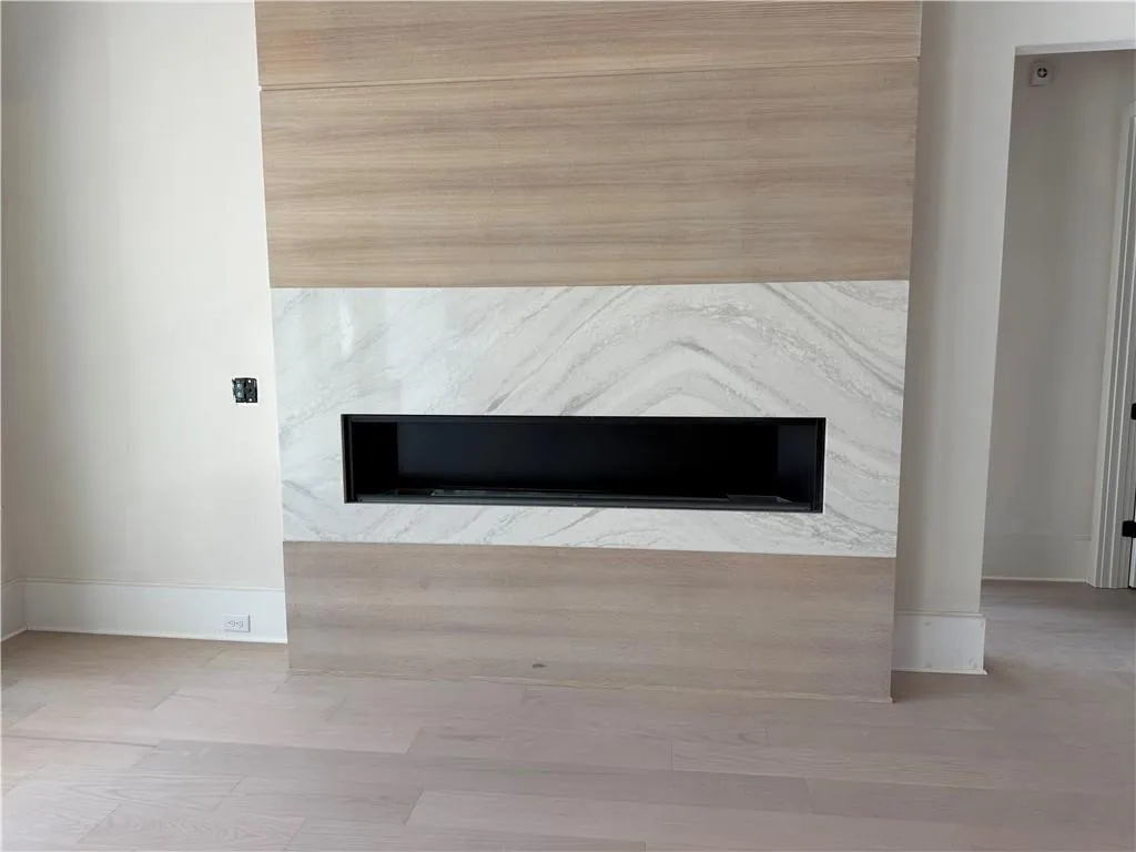 Detailed view of a high end fireplace and wood finished floors