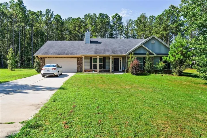 Single-story residence featuring a two-car garage, concrete driveway, and a front porch entry