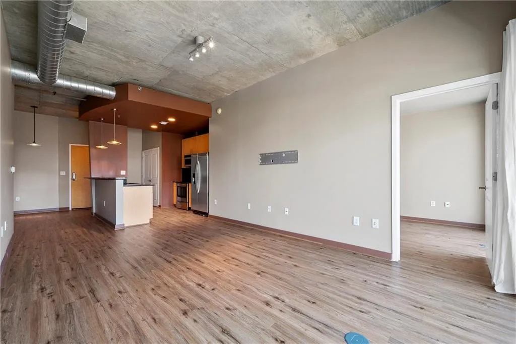 Unfurnished living room with light wood finished floors and baseboards